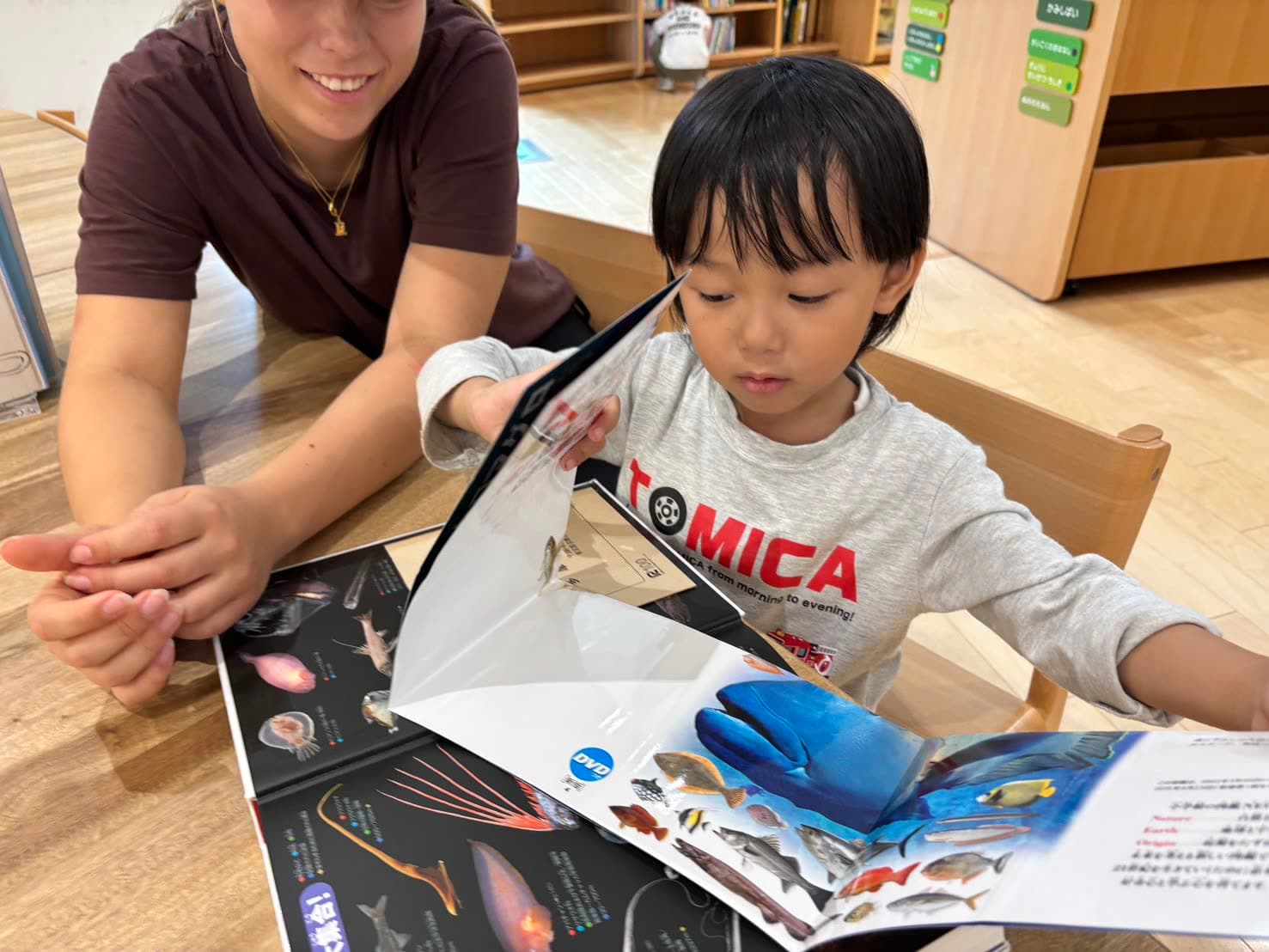 Reading a picture book about sea creatures with a child